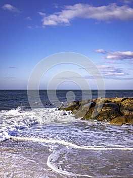 Beach Seascape with the Views of the Jetty and Curving White Tidal Waves