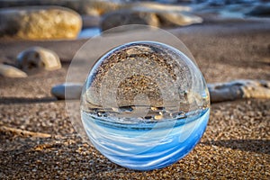 Beach seen in a glass ball