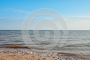 Beach on the shore of the ocean, the sea is a clear sunny summer