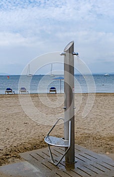 Beach shower on sandy beach in the sunny day at summer