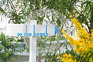 Beach sign on a wooden table. Beach access path