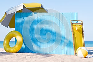 Beach Sign with Yellow Deck Chair, Umbrella, and Beach Ball