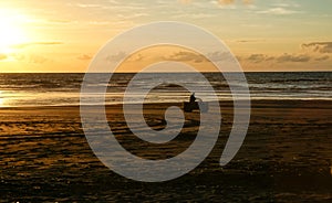 Beach in silhouette at sunset