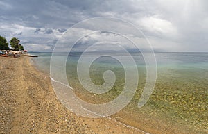 Beach and sky on Aegean Sea in Greece before rain and thunderstorm
