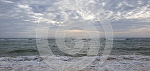 Beach and sky is full of clouds ,sun is also blocked by clouds