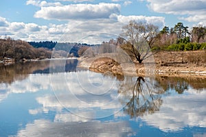 Beach and sky reflected in the river