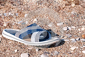 Beach slipper on a sandy beach on a summer day