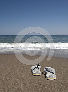Beach slippers on a sandy beach