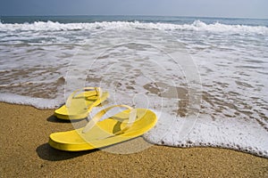 Beach slippers on a sandy beach