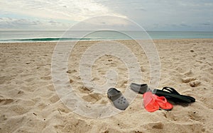 Beach slippers on the sandy beach