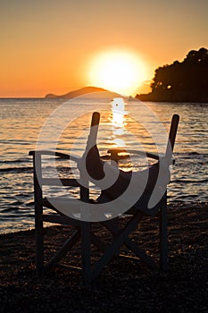 Beach with small director like chair at sunset in Sithonia