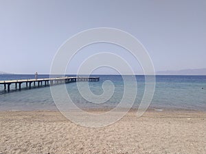 Beach with small wood pier
