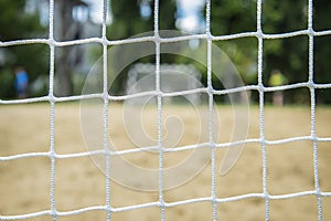 Beach soccer football goal through the net. Games in Brazil.