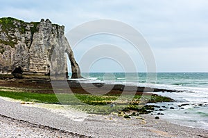 The beach and stone cliffs in Etretat, France