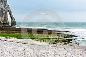 The beach and stone cliffs in Etretat, France