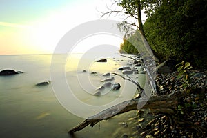 Beach stone coast with frozen water