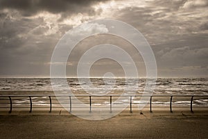 Beach on a stormy day with sun rays breaking through the clouds