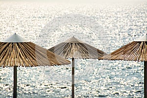 Beach straw umbrellas on the background of the Mediterranean Sea