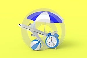 Beach striped umbrella, ball, airplane and alarm clock on yellow background