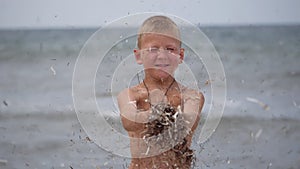 Beach summer vacation. Children's emotions. The child develops tinsel in the wind.