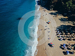 Beach with sun loungers on the coast of the ocean