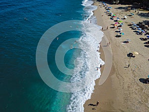 Beach with sun loungers on the coast of the ocean