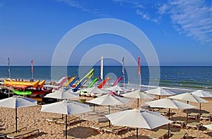 Beach sun loungers, umbrellas and floating games in MatalascaÃÂ±as Beach photo