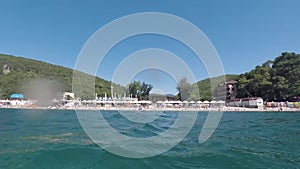 Beach with sunbathers in summer.