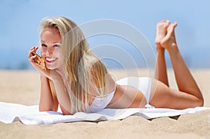 Beach, sunbathing and woman with smile, relax and bikini for summer vacation, break and holiday. Adult, girl and female