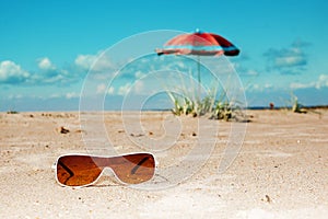 Beach sunglasses umbrella sea and sky