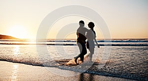 Beach sunset, sea water and silhouette couple walking, connect or enjoy romantic holiday in South Africa. Love, ocean