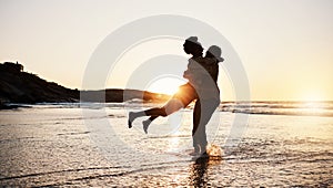 Beach sunset, silhouette and couple hug, celebrate and enjoy romantic time together, bonding and relax in sea water