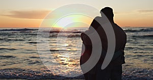 Beach sunset, silhouette or relax couple hug, bond and travel on nature vacation, anniversary date or island holiday