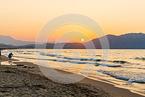 Beach on sunset in village Kavros in Crete island, Greece.