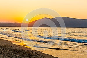 Beach on sunset in village Kavros in Crete island, Greece. Magical turquoise waters, lagoons.