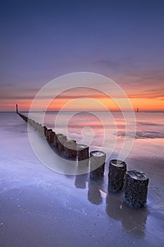 Beach at sunset in Zeeland, The Netherlands photo