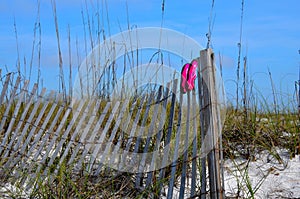 Beach swim shoes drying on fence at Florida beaches