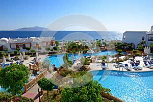 The beach with swimming pools at luxury hotel