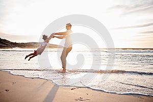 Beach, swing and father with girl child holding hands in nature for play, freedom or bond at sunset. Ocean, travel and