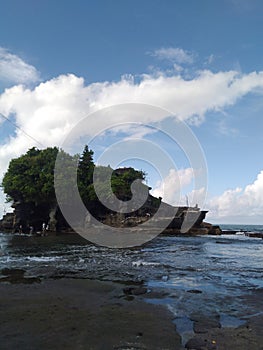 Beach Tanah Lot in Bali and blue sky with bright clouds