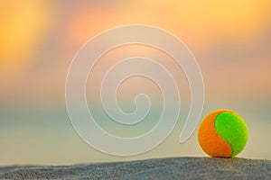 Beach tennis ball. Background with copy space. Sport court at the beach and ball.