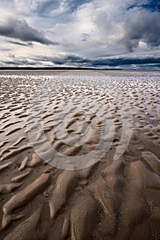 Beach textures at low tide with dramatic sky