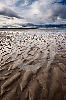 Beach textures at low tide with dramatic sky