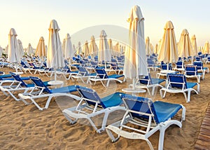 beach to sea with sun beds and folded umbrellas, Turkey, Side resort