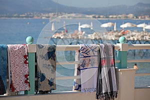 Beach towels against a bay in French Riviera