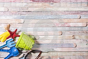 Beach toys on grunge wooden background. Holiday and vacation concept