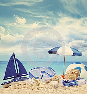 Beach toys on sandy beach with blue sea