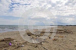 Trash on Catania beach and the Ionian sea