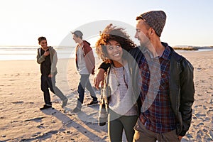 Beach, travel or couple of friends walking in nature for vacation, bonding or holiday together at sunset. Happy, journey