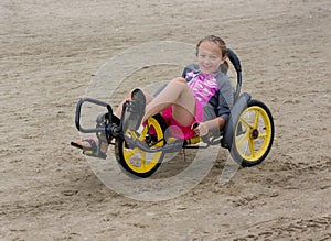 Beach trike with young child rider. Tricycle Bike Sandy Beach